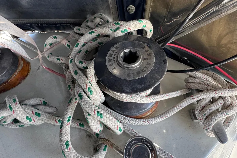 Winch and ropes on a 1989 Ericson Sloop sailboat deck.