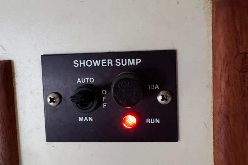 Control panel for shower sump on 1989 Ericson Sloop, featuring auto and manual settings.