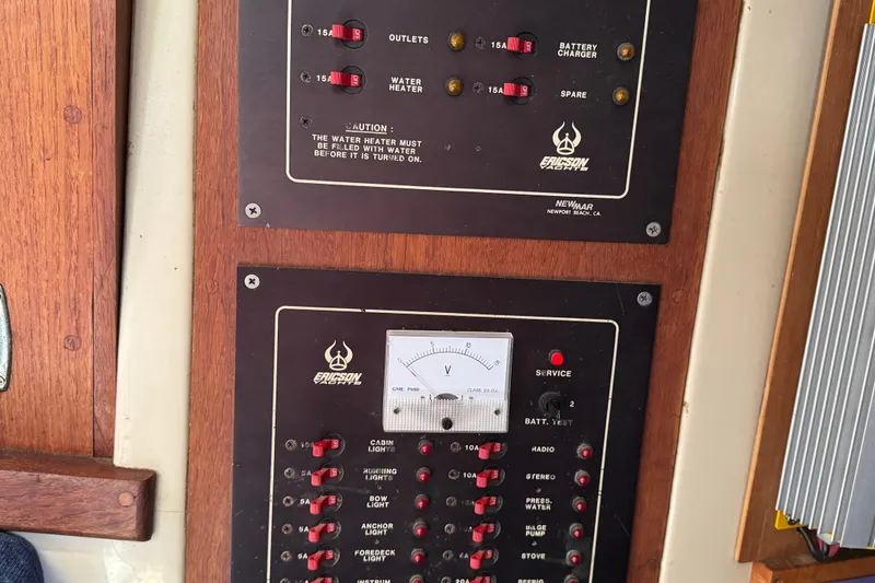 Electrical panel on a 1989 Ericson Sloop sailboat, featuring switches and a voltmeter.