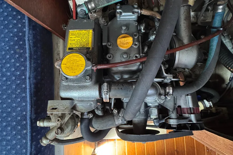 Engine compartment of a 1989 Ericson Sloop sailboat, showcasing mechanical components.
