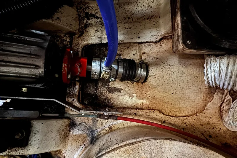 Engine compartment of a 1989 Ericson Sloop with visible hoses and fittings.