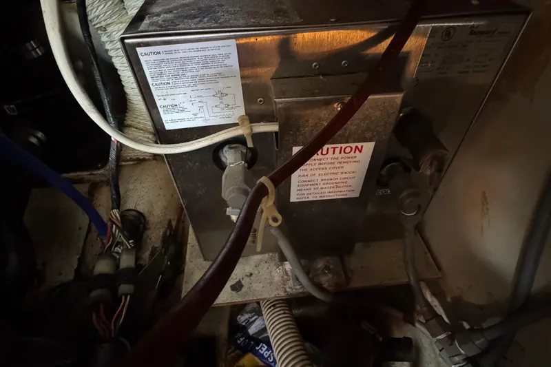 Electrical system inside 1989 Ericson Sloop, featuring wiring and caution labels.