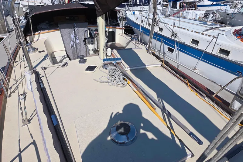 Deck view of a 1978 Islander Freeport 41 sailboat in a marina.