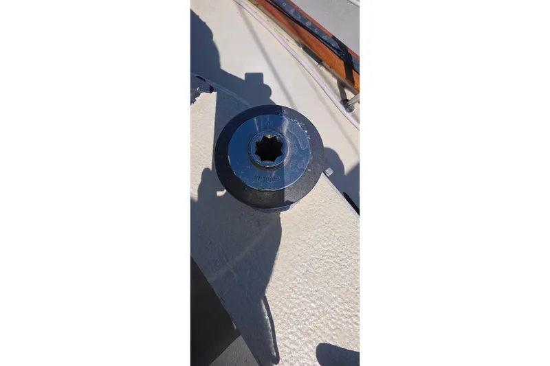 Winch on deck of 1978 Islander Freeport 41 sailboat, under sunlight.