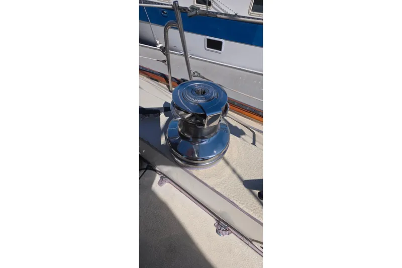 Chrome winch on 1978 Islander Freeport 41 sailboat deck, reflecting sunlight.