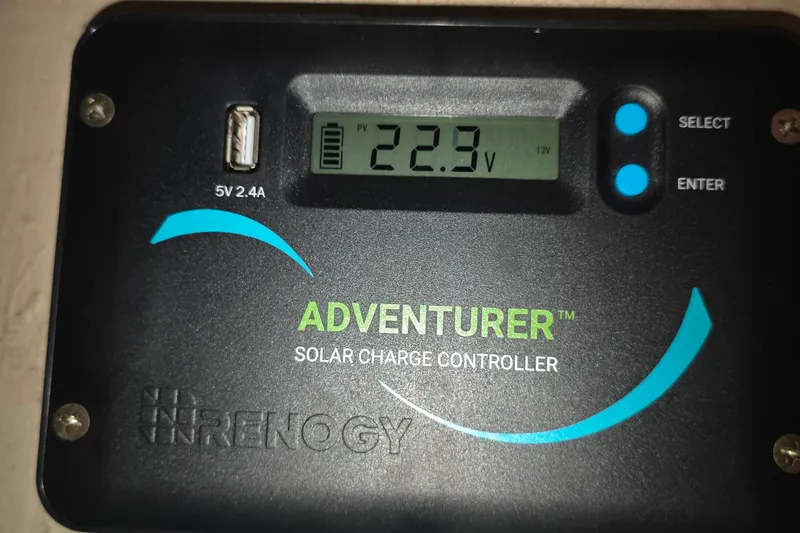 Renogy Adventurer solar charge controller displaying 22.9V, installed on a 1978 Islander Freeport 41.