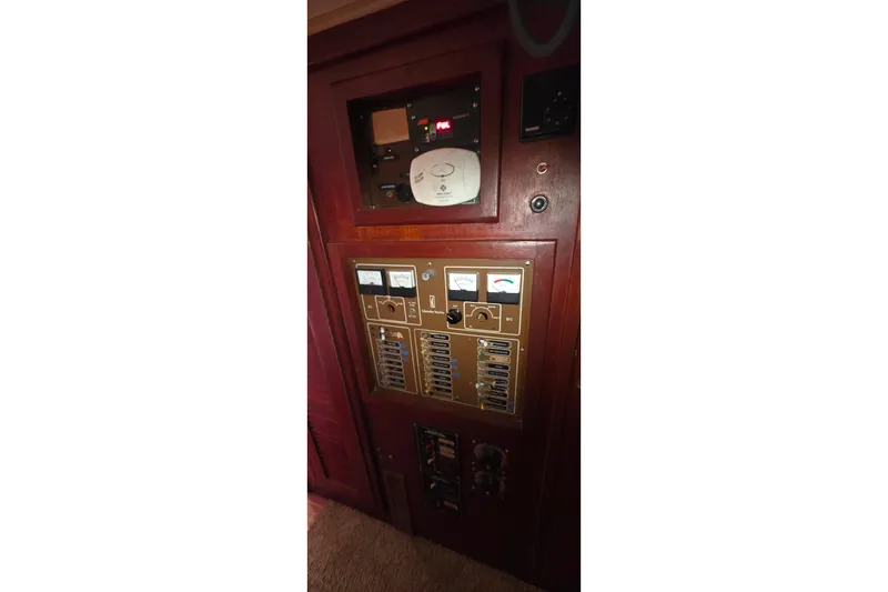 Electrical control panel on a 1978 Islander Freeport 41 sailboat, featuring gauges and switches.