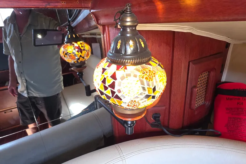 Interior of 1978 Islander Freeport 41 with mosaic lamp and marine safety kit.