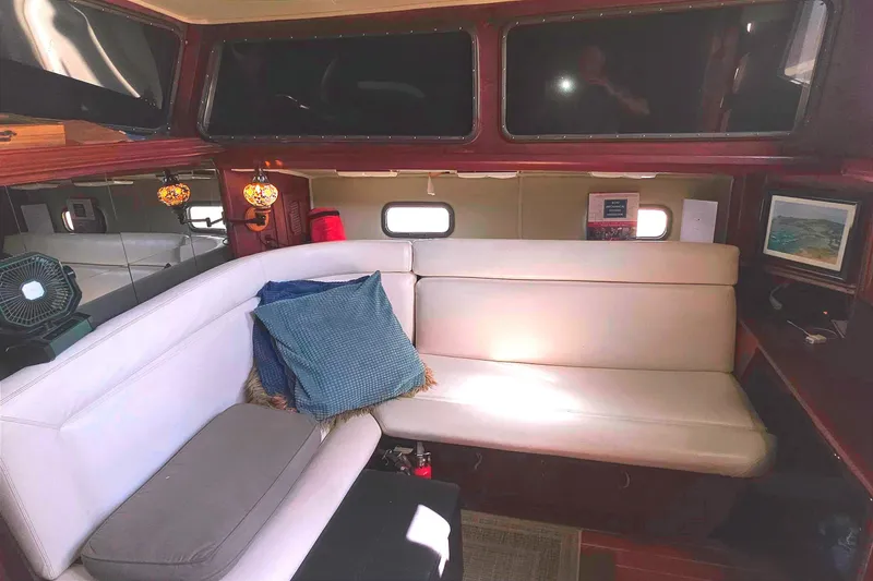 Interior of 1978 Islander Freeport 41 yacht with cozy seating and decorative lighting.