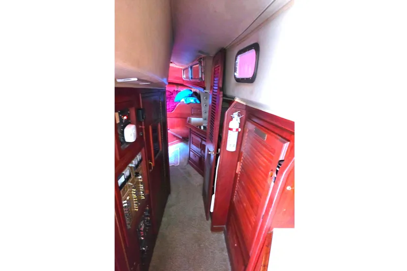 Interior view of 1978 Islander Freeport 41 sailboat, featuring wooden cabinetry and cozy hallway.