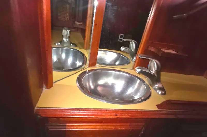 Stainless steel sink and faucet in 1978 Islander Freeport 41 yacht bathroom.