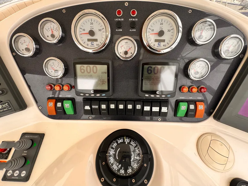 Control panel of a 2004 Riviera 47 Flybridge with gauges and navigation instruments.