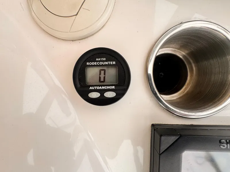 Riviera 47 Flybridge 2004 boat dashboard with rode counter and cup holder.