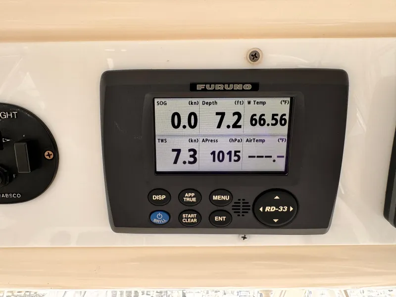 Furuno marine display on 2004 Riviera 47 Flybridge showing speed, depth, and temperature readings.