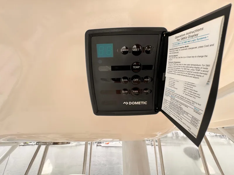 Dometic control panel on 2004 Riviera 47 Flybridge yacht, displaying operation instructions.