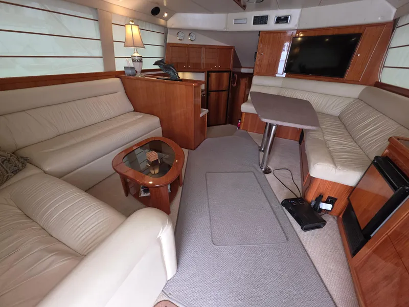 Luxurious interior of a 2004 Riviera 47 Flybridge yacht with elegant seating and modern amenities.