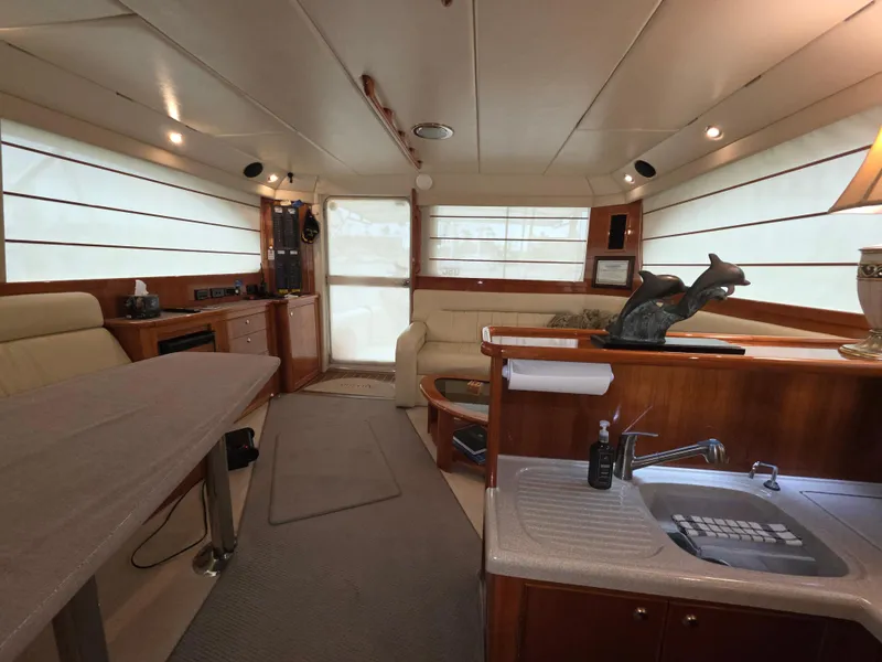Interior of 2004 Riviera 47 Flybridge yacht with elegant seating and kitchenette.