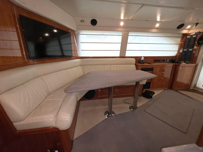 Luxurious interior of 2004 Riviera 47 Flybridge yacht with leather seating and modern amenities.