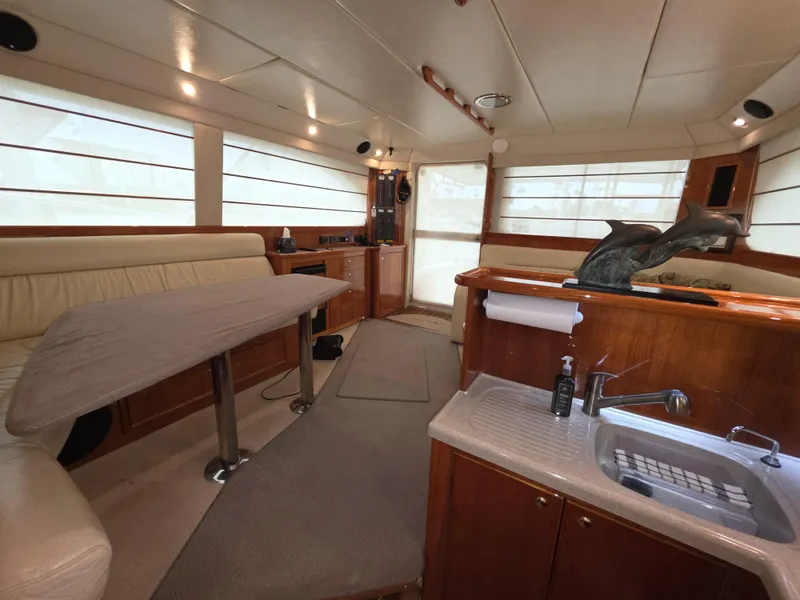 Interior of 2004 Riviera 47 Flybridge yacht with elegant seating and kitchenette.