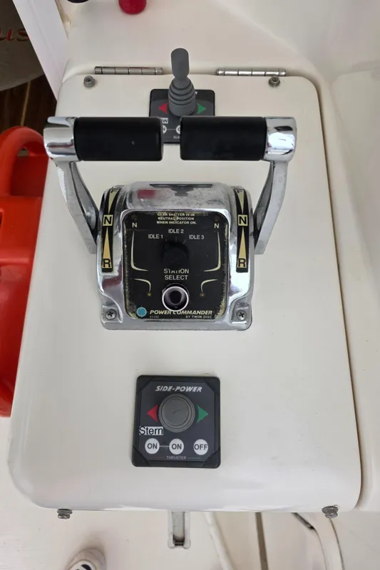Control panel of a 2004 Riviera 47 Flybridge boat with throttle and joystick.