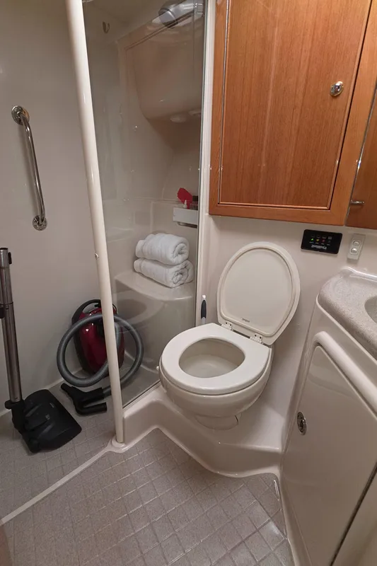 2004 Riviera 47 Flybridge bathroom with shower, toilet, and storage cabinet.