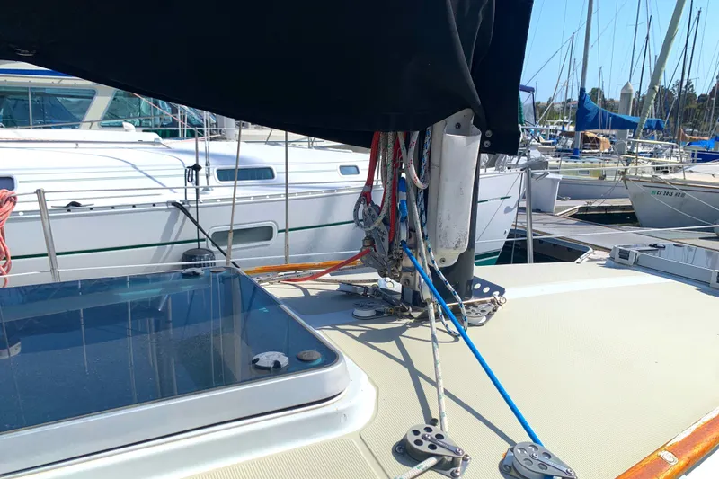 1984 Ericson 30 Plus sailboat deck with rigging and marina background.