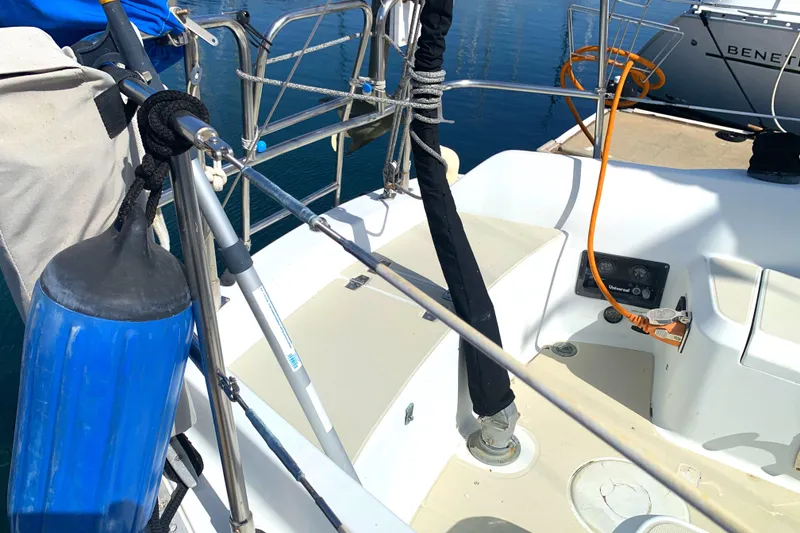Cockpit of 1984 Ericson 30 Plus sailboat with blue fender and docked at marina.