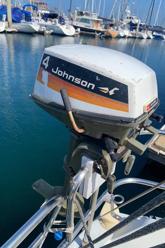 Outboard motor on 1984 Ericson 30 Plus sailboat at marina.