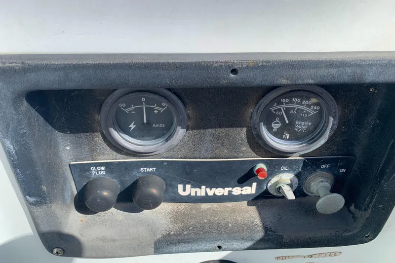 Control panel of a 1984 Ericson 30 Plus sailboat with gauges and switches.