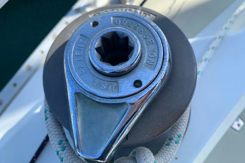 Winch mechanism on 1984 Ericson 30 Plus sailboat, featuring a rope and metallic gear.