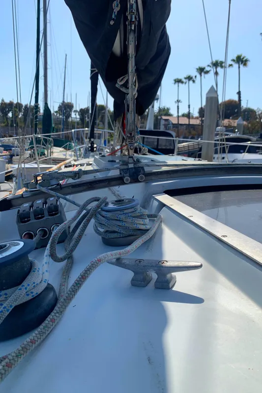 1984 Ericson 30 Plus sailboat deck with ropes and winches in a marina.
