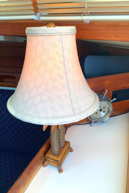 Vintage lamp inside 1984 Ericson 30 Plus yacht cabin, featuring nautical decor.