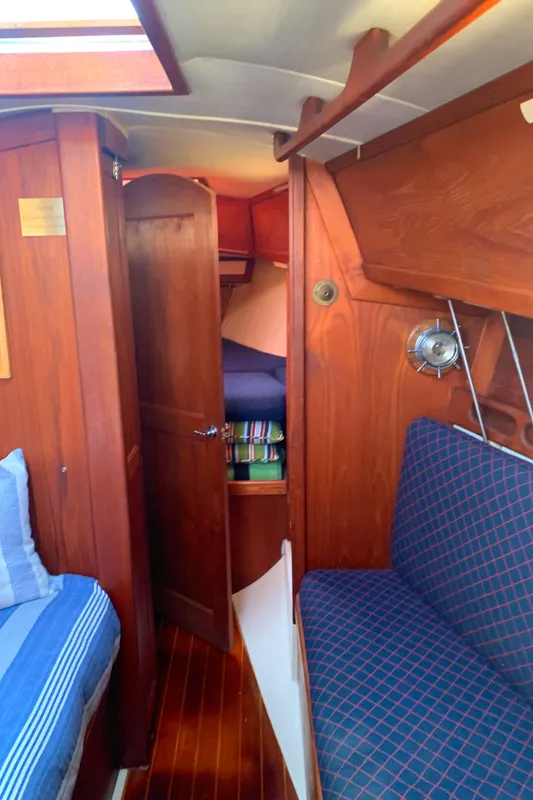 Interior of 1984 Ericson 30 Plus sailboat with wooden finish and cozy seating.