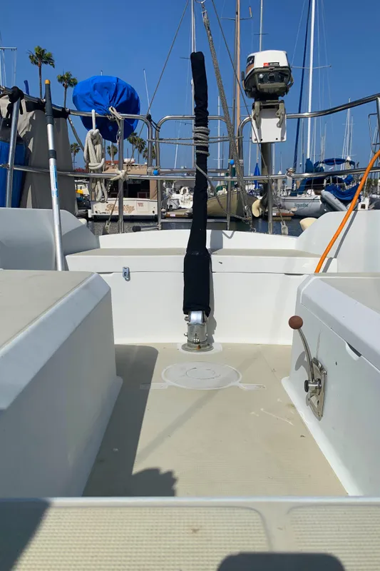 1984 Ericson 30 Plus sailboat cockpit with marina background.