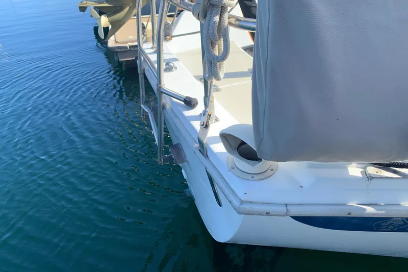 1984 Ericson 30 Plus sailboat stern view on calm water.