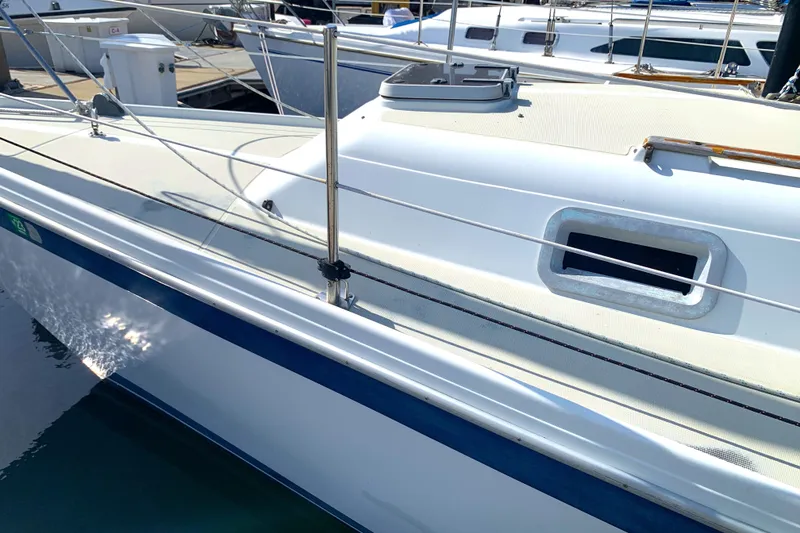 1984 Ericson 30 Plus sailboat docked, showcasing sleek deck design and porthole.
