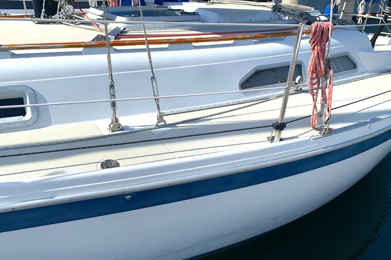 1984 Ericson 30 Plus sailboat deck with railing and ropes.