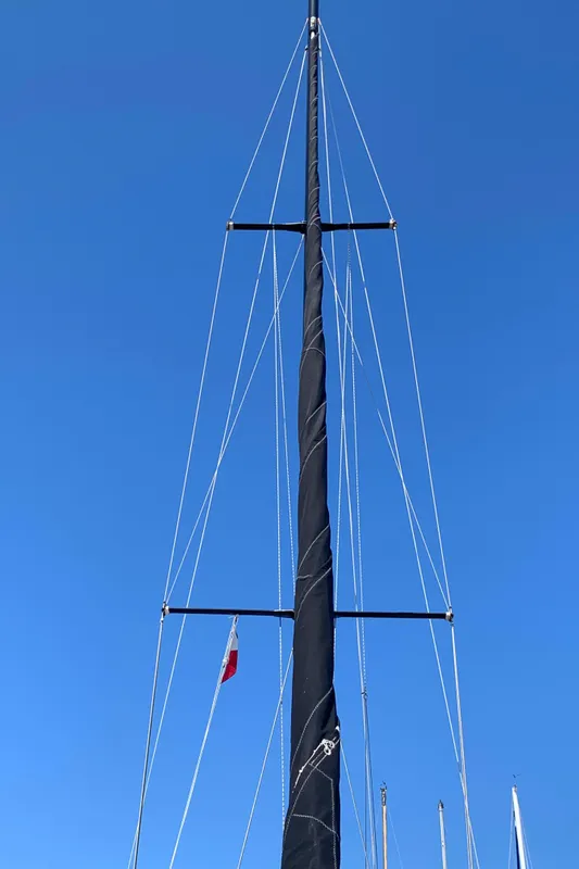 Mast of 1984 Ericson 30 Plus sailboat against clear blue sky.