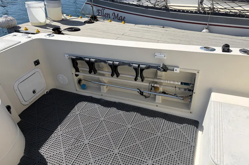1991 Donzi 255 LXC boat interior with storage compartment and fishing rod holders.