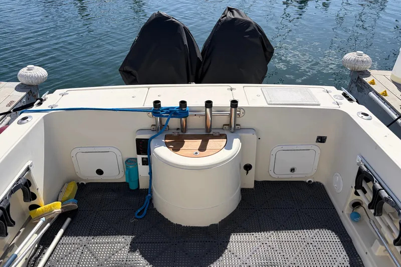1991 Donzi 255 LXC boat stern view with covered engines at dock.