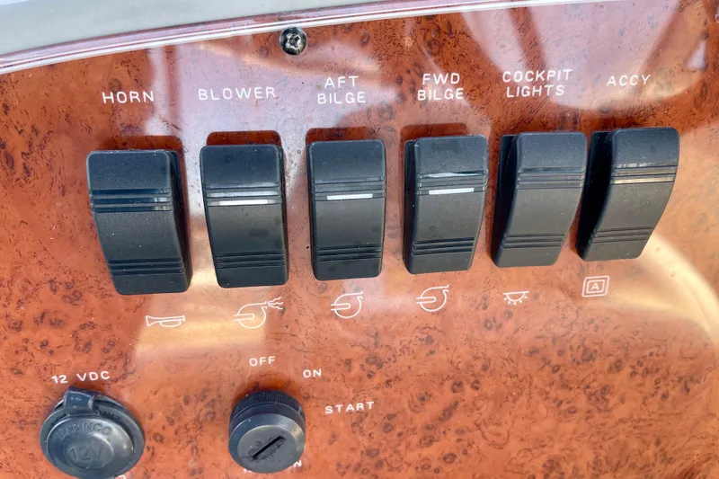 Control panel of a 2008 Bayliner 265 boat with labeled switches.