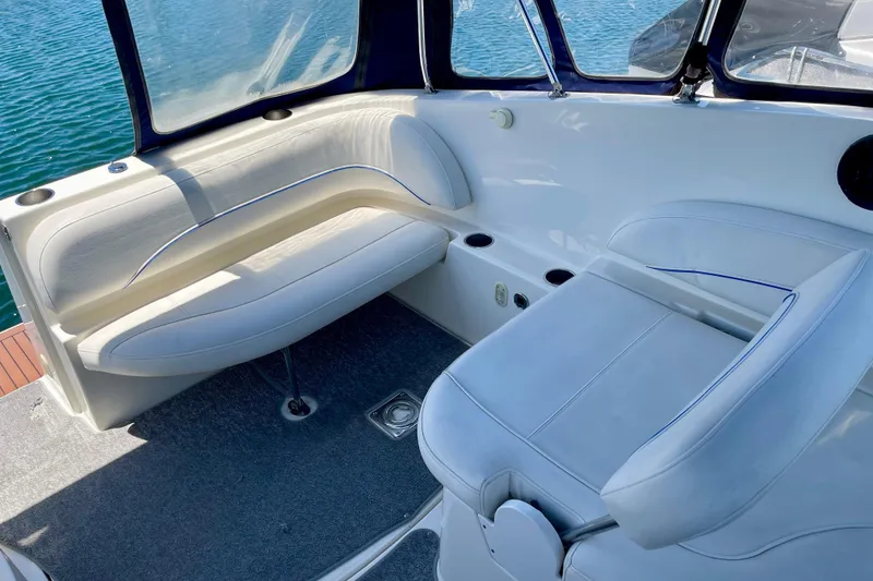 2008 Bayliner 265 boat interior with white seating and blue accents.