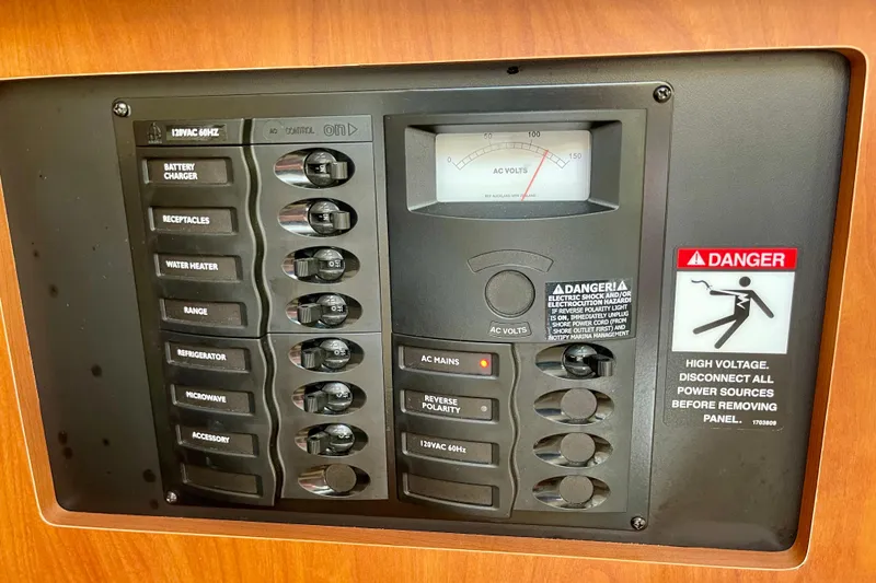 Electrical control panel on a 2008 Bayliner 265 boat with safety warnings.