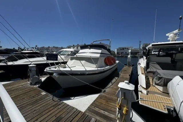 1972 Luhrs 32 Convertible boat docked at marina under clear blue sky.