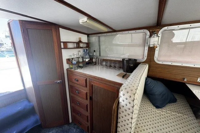 1972 Luhrs 32 Convertible cabin interior with wooden cabinetry and seating area.