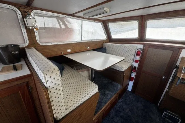 Interior of 1972 Luhrs 32 Convertible boat with dining area and wooden accents.