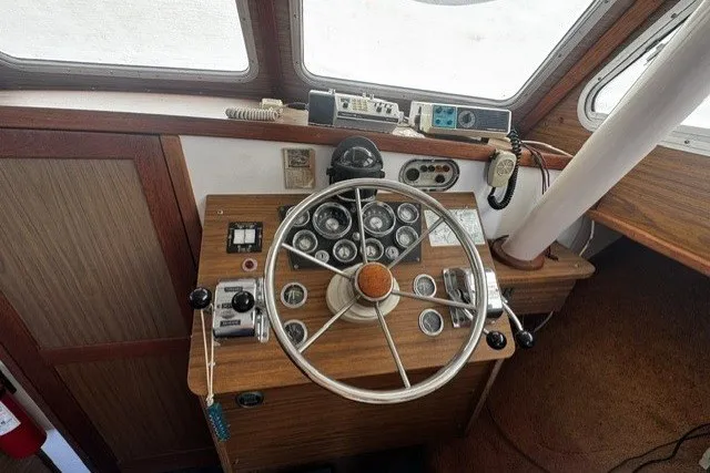 1972 Luhrs 32 Convertible boat helm with vintage steering wheel and control panel.