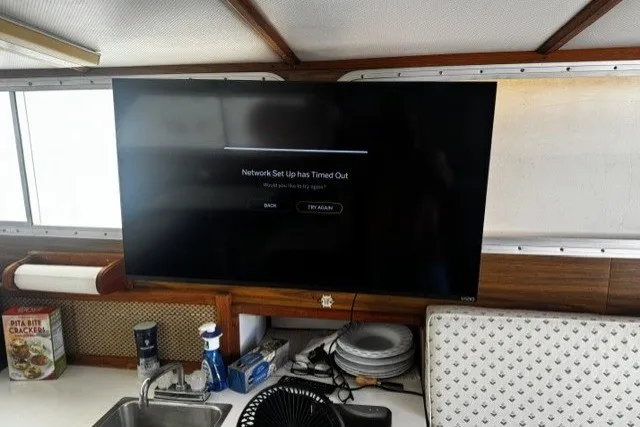 1972 Luhrs 32 Convertible interior with TV showing network setup timeout message.