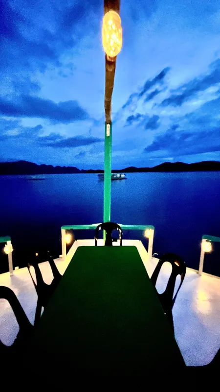 Phinisi 2016 Custom Pleasure Cruiser or Dive Boat at dusk with scenic ocean view.