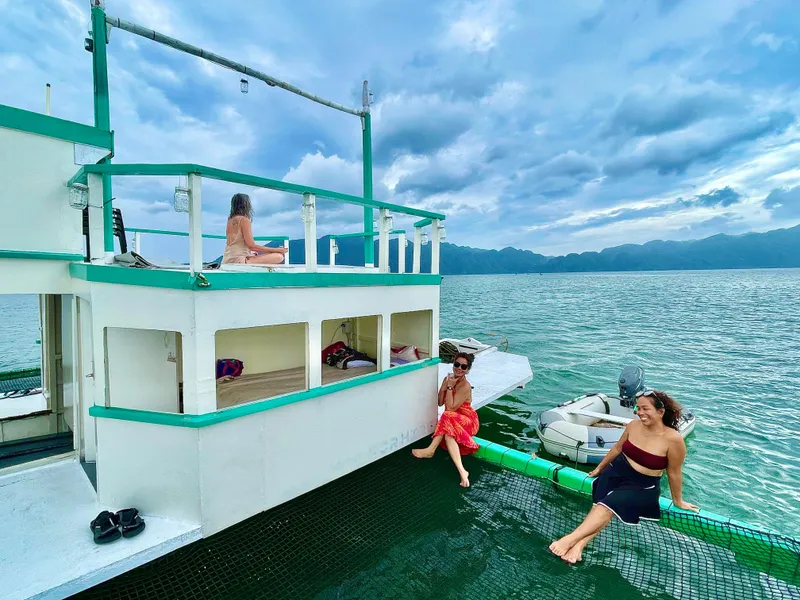 People relaxing on a 2016 Phinisi Custom Pleasure Cruiser or Dive Boat in scenic waters.